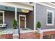 Charming covered front porch with brick steps, quaint decor and outdoor seating area at 629 Hansell Se St, Atlanta, GA 30312