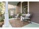 Covered front porch featuring comfortable seating on stylish chairs and a rug at 629 Hansell Se St, Atlanta, GA 30312