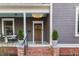 Charming covered front porch with brick steps, quaint decor and front door at 629 Hansell Se St, Atlanta, GA 30312