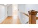 Hallway with wood floors and wood railing leading to the floor below, lit by skylight at 629 Hansell Se St, Atlanta, GA 30312