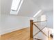 Bright hallway with hardwood floors, skylights, and a staircase with white railings at 629 Hansell Se St, Atlanta, GA 30312