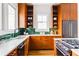 Modern kitchen with wood cabinets, green backsplash, stainless steel appliances and bright light at 629 Hansell Se St, Atlanta, GA 30312