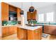 Modern kitchen featuring wood cabinets, an island with a gas range, and a unique green backsplash at 629 Hansell Se St, Atlanta, GA 30312