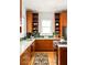 Custom kitchen featuring wood cabinetry, green tile backsplash, and stainless steel appliances at 629 Hansell Se St, Atlanta, GA 30312