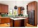 Modern kitchen with dark wood cabinetry, contrasting countertops and backsplash, and an island at 629 Hansell Se St, Atlanta, GA 30312