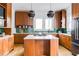 Modern kitchen with wooden cabinets, island, white countertops, and green tiled backsplash at 629 Hansell Se St, Atlanta, GA 30312