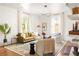 Well-lit living room showcasing a comfortable seating arrangement, chic decor, and polished hardwood floors at 629 Hansell Se St, Atlanta, GA 30312