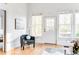 Cozy living room featuring a comfortable chair, large windows, and hardwood floors at 629 Hansell Se St, Atlanta, GA 30312