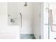 Shower with white tiled walls and patterned blue floor at 629 Hansell Se St, Atlanta, GA 30312