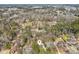 An aerial view of the property nestled among mature trees in a quiet residential neighborhood at 703 Somerset Dr, Lawrenceville, GA 30046