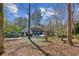 Backyard featuring a pool, large trees and lush foliage at 703 Somerset Dr, Lawrenceville, GA 30046