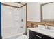 Bathroom featuring a shower-tub combo, white vanity and framed mirror at 703 Somerset Dr, Lawrenceville, GA 30046