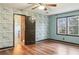 Bright bedroom featuring a ceiling fan, wood floors, and blue accent wall at 703 Somerset Dr, Lawrenceville, GA 30046