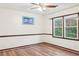 Bedroom with natural light, ceiling fan, and wood-look flooring at 703 Somerset Dr, Lawrenceville, GA 30046