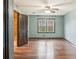 Bedroom featuring natural light, wood floors, and a blue accent wall at 703 Somerset Dr, Lawrenceville, GA 30046