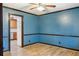 Living room featuring neutral wall paint, wood-look floors, and an open doorway to the kitchen at 703 Somerset Dr, Lawrenceville, GA 30046