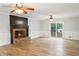 Large living room featuring a brick fireplace, sliding glass doors and light-colored wall paint at 703 Somerset Dr, Lawrenceville, GA 30046