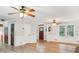 Spacious living room with wood floors, ceiling fans, and natural light at 703 Somerset Dr, Lawrenceville, GA 30046