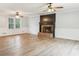 Bright living room featuring a brick fireplace and views of the yard at 703 Somerset Dr, Lawrenceville, GA 30046