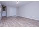 Spacious finished basement featuring modern light fixtures, wood-look flooring and stairs to the main level at 195 W Fork Way, Temple, GA 30179