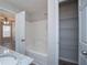 Bathroom featuring a shower over tub and shelving unit at 195 W Fork Way, Temple, GA 30179