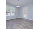 Bright dining area featuring wood-look floors, large window, and convenient access to the backyard at 195 W Fork Way, Temple, GA 30179
