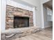 Detailed view of the stone fireplace with decorative white mantel and wood-look flooring at 195 W Fork Way, Temple, GA 30179