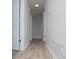 This hallway features luxury vinyl plank flooring, white doors, and white trim at 195 W Fork Way, Temple, GA 30179