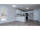 An open-concept kitchen with stainless steel appliances, gray walls, and wood flooring at 195 W Fork Way, Temple, GA 30179