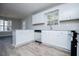 Bright kitchen with white cabinets, modern stainless steel appliances, and beautiful wood flooring at 195 W Fork Way, Temple, GA 30179