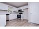 The open kitchen features white cabinets, stainless steel appliances, and modern flooring at 195 W Fork Way, Temple, GA 30179