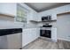 A well-lit kitchen featuring white cabinetry, stainless steel appliances, and modern countertops at 195 W Fork Way, Temple, GA 30179