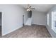 This living room features a ceiling fan, luxury vinyl plank flooring, and white trim at 195 W Fork Way, Temple, GA 30179