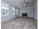Spacious living room with wood-look floors, a vaulted ceiling, and a stone fireplace at 195 W Fork Way, Temple, GA 30179