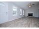 Spacious living room with wood-look floors, a vaulted ceiling, and a stone fireplace at 195 W Fork Way, Temple, GA 30179
