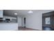 Open floor plan featuring kitchen with white cabinets, stainless steel appliances, and modern flooring at 195 W Fork Way, Temple, GA 30179