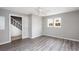 Bedroom has gray vinyl plank flooring, ceiling fan, closet and multiple windows at 2370 Mcafee Rd, Decatur, GA 30032