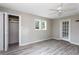 Bedroom with ceiling fan, gray vinyl plank flooring, closet and glass paneled doors at 2370 Mcafee Rd, Decatur, GA 30032