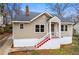 Charming home featuring a painted brick foundation, red stairs, and a quaint covered front porch at 2370 Mcafee Rd, Decatur, GA 30032