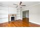 A bright living room features hardwood floors, a fireplace and built-in shelving at 2370 Mcafee Rd, Decatur, GA 30032