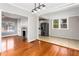 Open-concept living room with fireplace, hardwood floors and view into kitchen at 2370 Mcafee Rd, Decatur, GA 30032