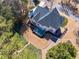 An aerial view of home with deck, patio, lush backyard, and manicured landscaping at 4780 Woodruff Trce, Cumming, GA 30028