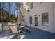 Inviting back deck features a seating area, with views of the serene, tree-lined backyard at 4780 Woodruff Trce, Cumming, GA 30028