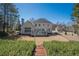 Rear view of the house with a green backyard and fence at 4780 Woodruff Trce, Cumming, GA 30028