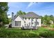 White siding house with large windows and well-kept lawn and a nice deck at 4780 Woodruff Trce, Cumming, GA 30028