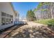 Sprawling backyard featuring manicured landscaping, a wooden deck ideal for outdoor dining, and mature trees at 4780 Woodruff Trce, Cumming, GA 30028