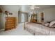 Comfortable bedroom featuring a ceiling fan, large window, and a wooden dresser at 4780 Woodruff Trce, Cumming, GA 30028