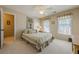 Cozy bedroom with neutral decor, soft carpet, and ample natural light creates a relaxing atmosphere at 4780 Woodruff Trce, Cumming, GA 30028