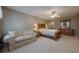 Sunlit Primary bedroom with a ceiling fan, sitting area, and classic furniture at 4780 Woodruff Trce, Cumming, GA 30028