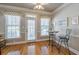 Bright breakfast nook with hardwood floors, three windows, and a door leading to the outside at 4780 Woodruff Trce, Cumming, GA 30028